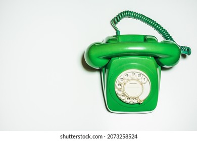 Top View Close Up Bright Green Retro Or Vintage Classic Iconic Device  From 70s 80s Desktop Wired Home Telephone Handset For Calls To Urban And Long-distance Lines Isolated On White Background.