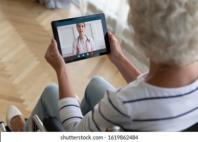 Top View Close Up Disabled Older Woman Sitting In Wheelchair, Using Computer Tablet, Looking At Screen, Forgot Password, Mature Female Holding Electronic Device In Hands, Problem With Memory