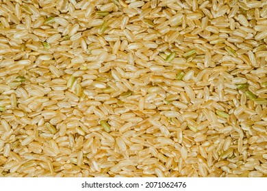 Top View Close Up Or Macro Of Pile Of Brown RiceBrown Rice Is A Whole Grain Rice With The Inedible Outer Hull Removed. White Rice Is The Same Grain Without The Hull, The Bran Layer, And Cereal Germ