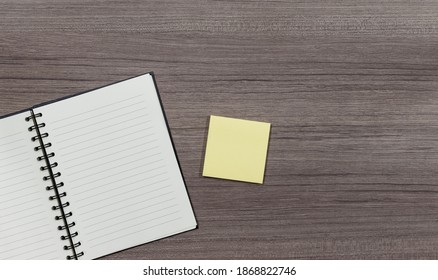 Top view close up notebook and yellow sticky note with copy space - Shutterstock ID 1868822746