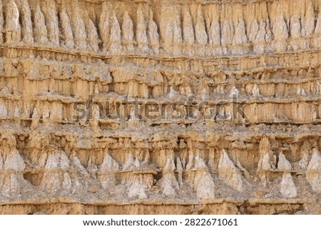 Top view close up texture of eroded clay soil stratum layer and earth pillars pattern