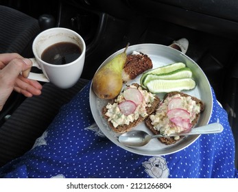 Top view close up of a typical breakfast. Wholegrain dark bread with mayonnaise and vegetable salad topped with radish, pieces of cucumber, pear and chocolate cake. Cup of black coffee Poland, Europe 