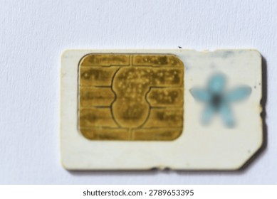 Top view close-up of different SIM card formats arranged on white textured surface, useful for concepts of mobile communication and digital connectivity
