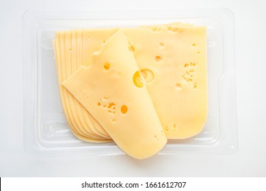 Top View Close-up Of Square Cheese Radamer Slices In A Package Isolated On A White Background. Slices Of Swiss Cheese.Maasdam - Dutch Hard Cheese With Large Holes.