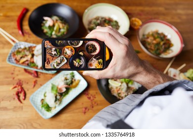 Top View Closeup Of Unrecognizable Man Taking Picture Of Asian Food Dishes, Copy Space