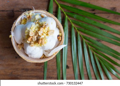 Top view of Coconut Milk Ice Cream in the coconut shell on rustic wooden table.
Thai dessert concept. 