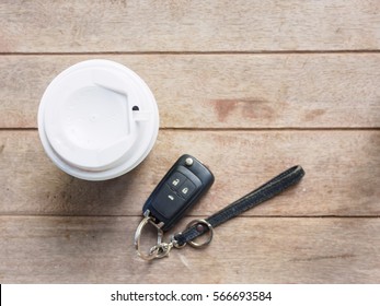 Top view coffee cup holder and  key car on wooden table with copy space