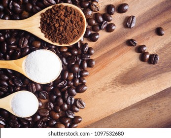 Top View Coffee Powder, Sugar Powder, Creamer Powder In Wooden Spoon And Coffee Beans On Wooden Table Background.