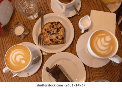 Top view of the coffee table with coffee cups and desserts