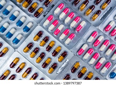 Top view of colorful antibiotic capsule pills in blister pack. Antibiotic drug resistance. Pharmaceutical industry. Pharmacy drug store background. Global health care concept. Antimicrobial capsule.
