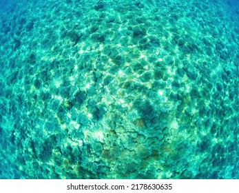 Top view of colorful azure water with stones and sea water top view background. - Shutterstock ID 2178630635