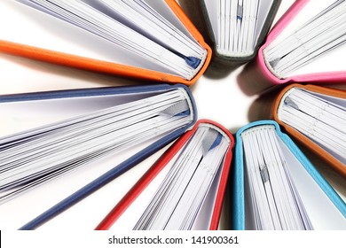 Top view of colorful books in a circle on white background - Shutterstock ID 141900361