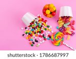 a top view colorful candies along with lollipop and marmalades isolated on the pink background sweet sugar color confiture