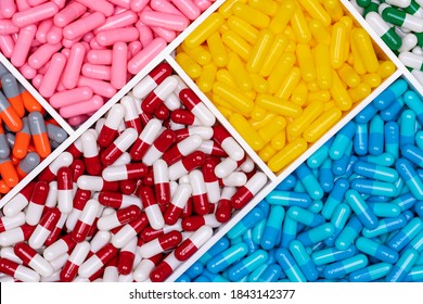 Top view of colorful capsule pills in plastic tray. Pharmaceutical industry. Healthcare and medicine. Drug production. Pharmaceutics concept. Vitamins and supplements capsules. Bright color capsule.