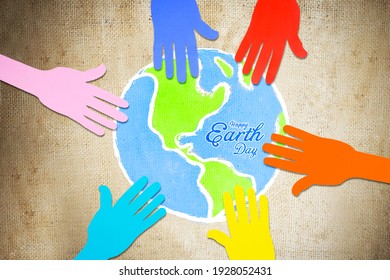 Top View Of Colorful Paper Hands Holding A Globe With Earth Day Text On A Sack Sheet Background