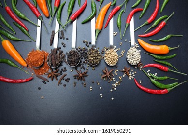 Top view colorful spices and peppers on black background. - Shutterstock ID 1619050291