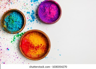top view of colorful traditional holi powder in bowls isolated on white 
