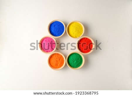 top view of colorful traditional holi powder in bowls isolated on white background.Space for text . happy holi.Concept Indian color festival called Holi