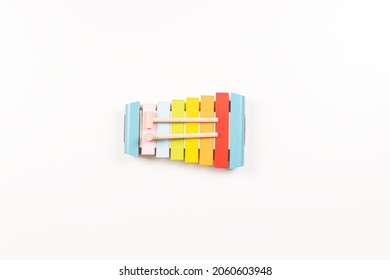 Top View To Colorful Wooden Xylophone With Sticks On White Background. Early Education For Kids. Learning Music For Children. Educational Montessori Toys