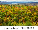 A top view of colourful forest trees and lake in the autumn season.  Scene from Lookout Trail Algonquin Park Ontario, Canada 