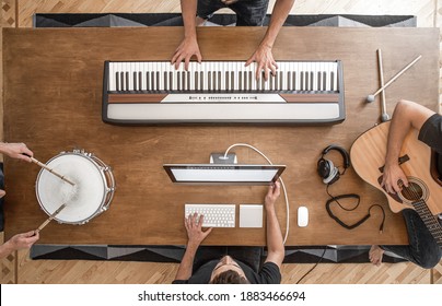 Top view of a composition of musical instruments on a wooden table in a recording studio. Musician's workplace for creativity.