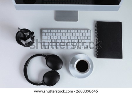 Top View Of Computer, Coffee, Notebook, And Headphones On Office Desk