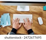 Top view, computer and hands typing in office for software project, research and closeup in creative startup. Above, web designer and person on keyboard for information technology, business and email