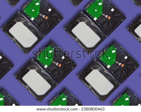 Top view of computer hard drives arranged on purple background.