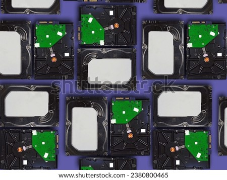 Top view of computer hard drives arranged on purple background.