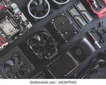 Top View Of Computer Parts With Harddisk, Ram, CPU, Graphics Card, And Motherboard On Black Table Background.