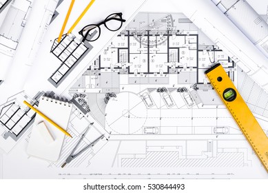 Top View Of Construction Plans With Tablet, Drawing And Working Tools On Blueprints; Architectural And Engineering Housing Concept.