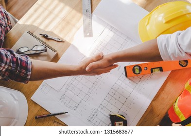 Top View Construction Worker Team Contractor Hand Shake After Finishing Up Business Meeting To Greeting Start Up Project Contract In Construction Site Building, Teamwork, Partnership, Industry Concept