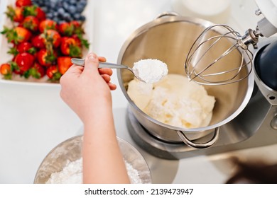 Top View. A Cook Adds A Spoonful Of Flour To Prepare Dough In A Mixer Bowl. Cooking Courses. Bread And Dessert Recipes. Family Business. Online Lessons For Cooks.