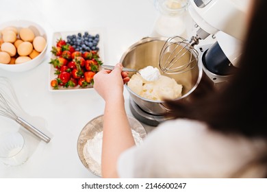 Top View. A Cook Adds A Spoonful Of Flour To Prepare Dough In A Mixer Bowl. Cooking Courses. Bread And Dessert Recipes. Family Business. Online Lessons For Cooks.