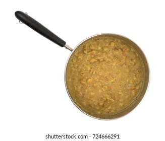 Top View Of Cooked Leftover Yellow Split Pea Soup With Vegetables In A Metal Pan Isolated On A White Background.