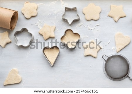 Top view of cooking a gingerbread cookie in the form of heart, star, cloud and flower. Christmas and New Year concept, festive preparations for winter hilodays.