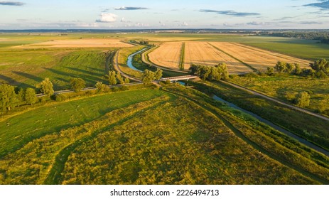 Top view of the countryside, agricultural fields, river and road bridge across the river - Powered by Shutterstock