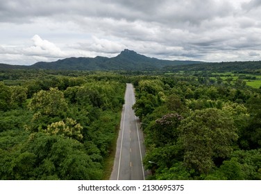 Top View Of Countryside Road Passing Through The Green Forrest And Mountain