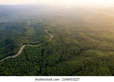 Top View Of Countryside Road Passing Through The Green Forrest And Mountain