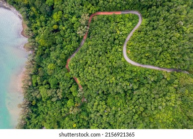 Top View Of Countryside Road Passing Through The Green Forrest And Mountain