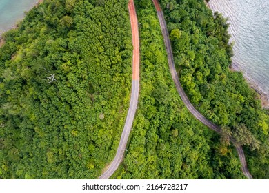 Top View Of Countryside Road Passing Through The Green Forrest And Mountain