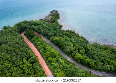 Top View Of Countryside Road Passing Through The Green Forrest And Mountain