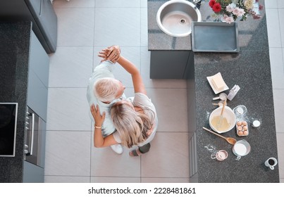 Top view couple, dancing and home kitchen for cooking, happy romance or love bonding together. Senior man, woman dancer or dance movement on floor for steps, touch and retirement house with food - Powered by Shutterstock