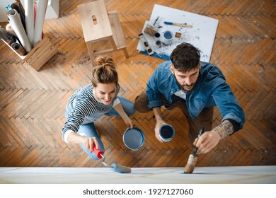 Top View Of Couple Painting Wall Indoors At Home, Relocation And Diy Concept.