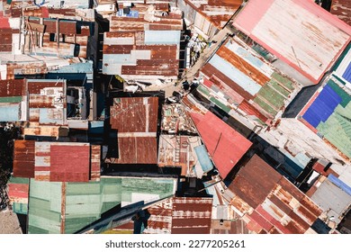 Top view of cramped shanty houses with roofs made of rusted sheet metal at a slum area in Metro Manila.