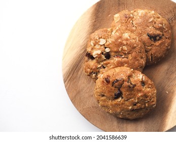 Top View Cranberry Oatmeal Cookies On Wooden Plate On White Background