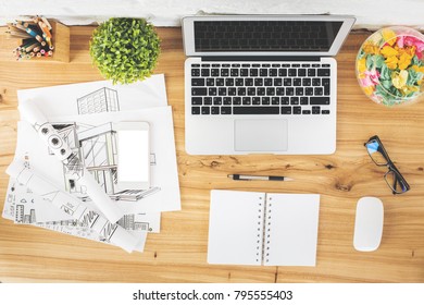 Top view of creative designer table with empty gadgets, supplies and architectural sketch. Workplace and engineering concept. Mock up