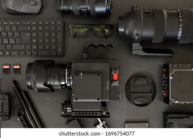 Top View of a Creative Filmmakers Office Desk with Lined up Camera and Gear