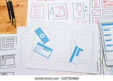 Top view of Creative flat lay UX designer working space and office supplies. Smartphone application layout prototype project.