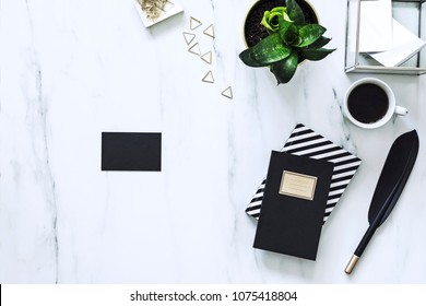 The Top View Of Creative Marble Desk With Cup Of Coffee, Plant And Notes. Concept For Mock Up Clack Bussines Card.